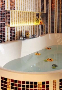 Styl koupelny určují luxusní materiály, smyslné barvy a vůně, řešení zvoucí k častému užíváni.